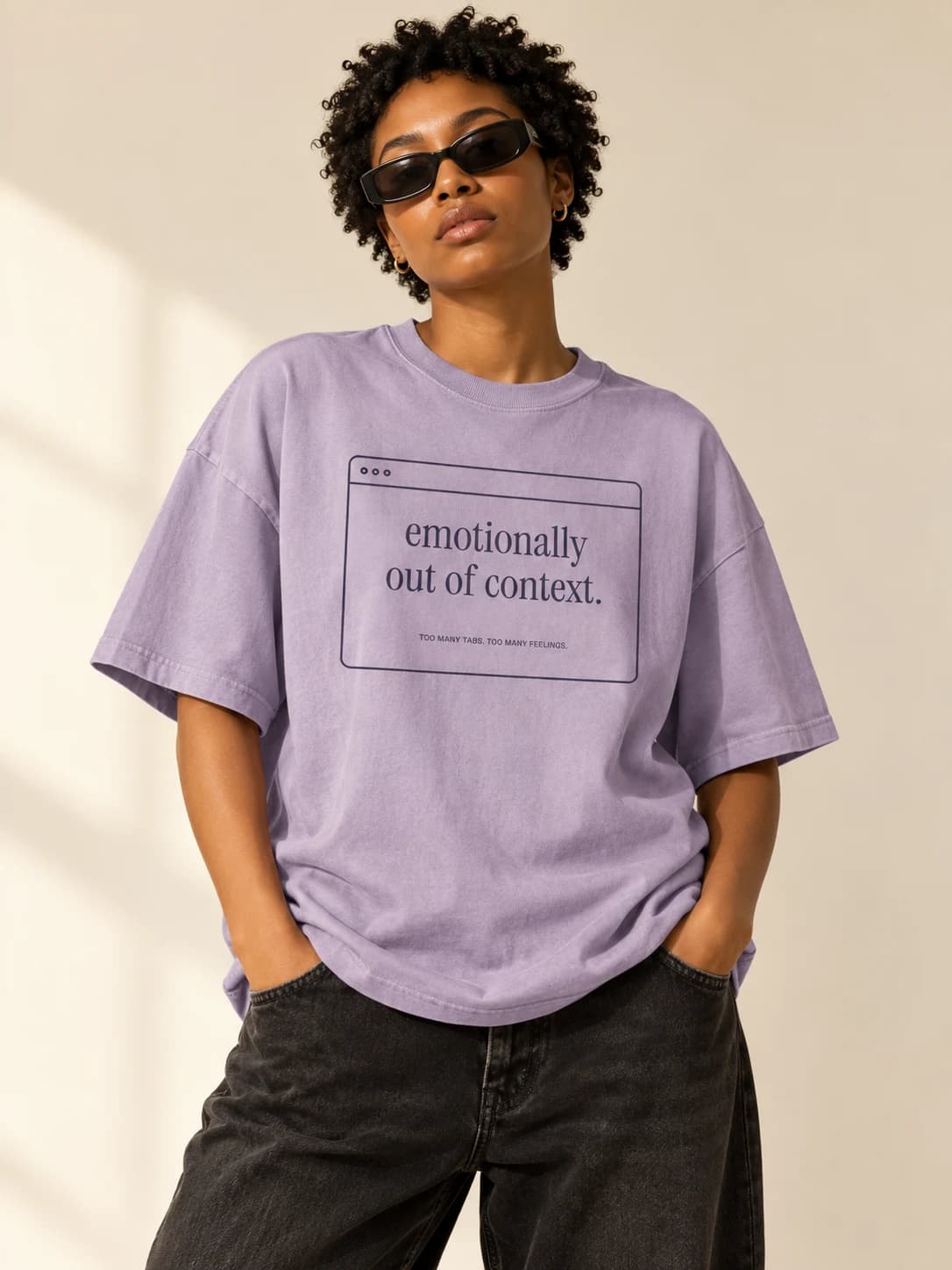 Emotionally out of context — model wearing Faded lilac tee, front