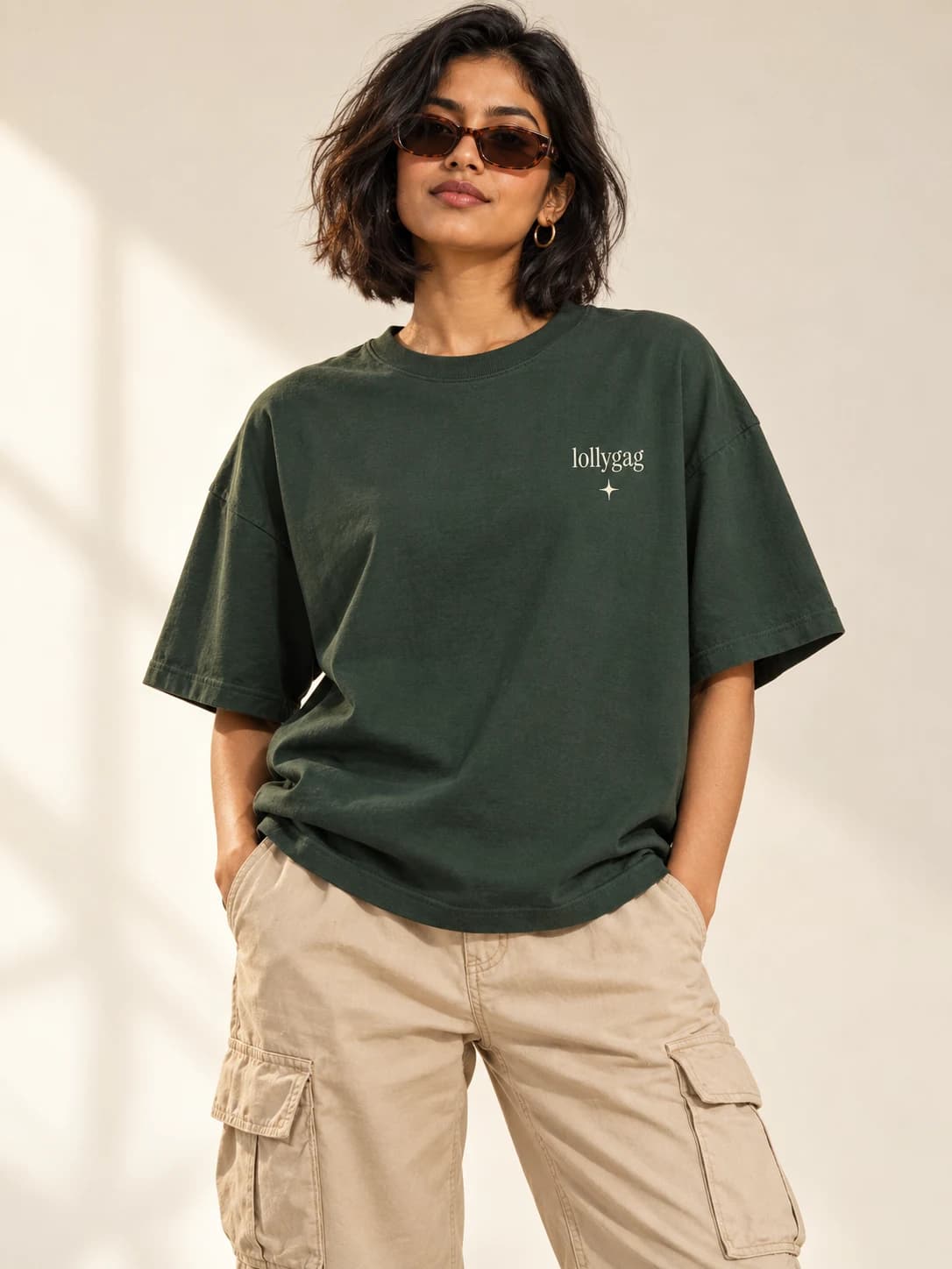 Touch grass. Stay grounded. — model wearing Forest tee, front